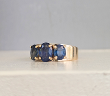 Load image into Gallery viewer, Striking natural blue sapphire trilogy in rosey 9ct yellow gold