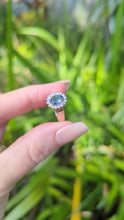 Load and play video in Gallery viewer, 1980s Halo ring with Teal sapphire and white spinel in 9ct yellow and white gold.
