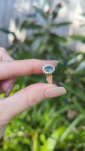 Load and play video in Gallery viewer, 1980s Halo ring with Teal sapphire and white spinel in 9ct yellow and white gold.
