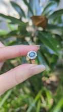 Load and play video in Gallery viewer, 1980s Halo ring with Teal sapphire and white spinel in 9ct yellow and white gold.
