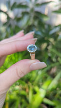 Load and play video in Gallery viewer, 1980s Halo ring with Teal sapphire and white spinel in 9ct yellow and white gold.
