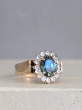 Load image into Gallery viewer, 1980s Halo ring with Teal sapphire and white spinel in 9ct yellow and white gold.
