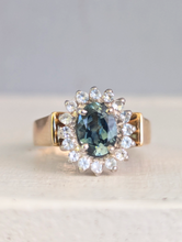 Load image into Gallery viewer, 1980s Halo ring with Teal sapphire and white spinel in 9ct yellow and white gold.
