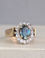 Load image into Gallery viewer, 1980s Halo ring with Teal sapphire and white spinel in 9ct yellow and white gold.
